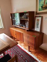 Overall view of two-piece teak hutch assembled in corner of room