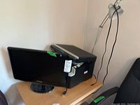 Samsung 20 inch monitor and Brother printer visible on a wooden desk with cables, lamp arm partially visible