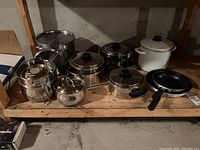 Full view showing all pots and pans including stainless steel, ceramic, and frying pans