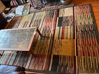 Full view of the multicolor abstract patterned area rug with rectangles and linear designs placed on wooden floor with a coffee table on top.