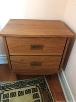 Front view of teak end table with both drawers closed