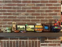 Full shelf overview showing all vases, paintings, dishes, decorative pieces and empty box