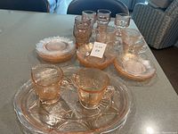 Overview of entire 28-piece glass dish set on table.