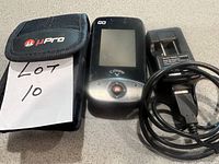 Callaway GPS device with screen and control button, WiPro carrying case, and USB charger with cable laid out on flat surface.