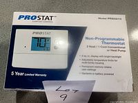 Box of Pro Stat PRS3210 Non-Programmable Thermostat showing model, features, and warranty information.