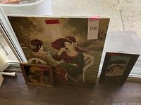 Photo of three artworks grouped on the floor showing size and framing