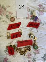 All four rings and charm bracelet laid out with karat tags visible