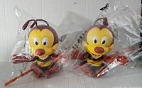 Pair of Disney Spike the Bee sipper cups still in their clear plastic packaging showing front and arms outstretched.