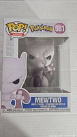 Front of the boxed Pokemon Mewtwo Funko Pop #581, showing the figure clearly through window display and detailed branding.