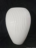 Full view of the cream-colored Lenox vase showing the textured vertical swirl pattern on its surface, against a black background.