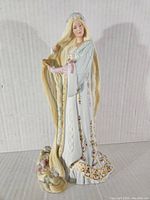 Full front and side view of the Lenox Rapunzel ceramic figurine showing intricate details of gown, hair, and floral base.