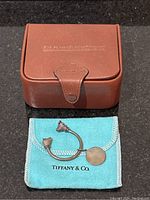 Brown Barrington gift box with snap closure, Tiffany pouch and silver key ring displayed