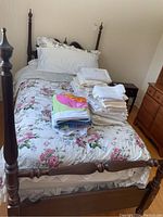 Full assembled twin bed frame with decorative bedding illustrating scale