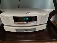 Front view of Bose Wave system main unit stacked on CD changer showing digital display reading “2:55”