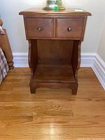 Full view of Kroehler Cape Cod wooden night stand; drawer and open cubby visible