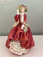 Front view of the Royal Doulton Top o' the Hill porcelain figurine showing detailed dress and face.