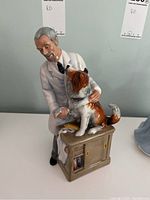 Front view of the Royal Doulton 'Thanks Doc!' HN 2731 porcelain figurine showing the veterinarian and dog on the exam table.