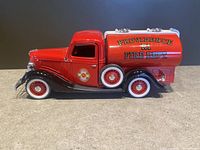 Side view of red 1936 Ford Citerne toy fire truck with Providence RI Fire Dept. markings, showing whitewall tires and silver detailing.