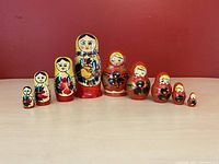 Two sets of vintage Russian wooden nesting dolls arranged side by side showing all dolls outside.