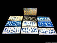 Full display of all 10 vintage Ontario license plates from 1948 to 1972 arranged in two rows on a black cloth background.