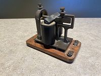 Front-angle view of the vintage Western Electric telegraph sounder showing wooden base and metal mechanism.