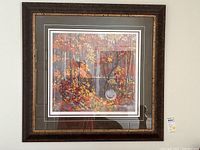 Framed print of Tom Thomson's The Pool showing autumn forest scene in vibrant colors.