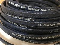 Close-up image of coiled Phillips 1412 NMD-7 copper wiring showing printed markings on cable sheath.