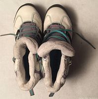 Pair of white Adidas Continental girls shoes with purple and turquoise details, viewed from above showing the fur lining inside.