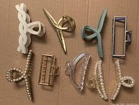 Top view of all 9 assorted hair clips showing variety of colors, materials and designs.