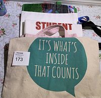 Canvas tote bag with quote text on cream fabric with handles.
