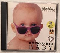 Front view of the CD cover showing baby wearing purple sunglasses and the Walt Disney Records logo.