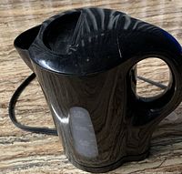 View of the black Proctor Silex cordless electric kettle showing the handle, spout, hinged lid, and water level indicator.