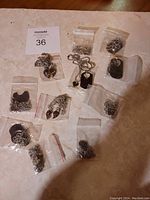 Top view of all 11 necklaces individually bagged on a surface