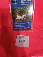 Original retail packaging front showing PetSafe cat harness and leash with usage info and image of cat wearing harness.