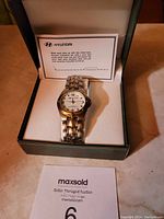 Photo of the Hyundai branded watch in its original box with care instructions visible.