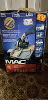 Boxed MAC Board 1 electric mitre saw with mitre board, showing product image and packaging details.
