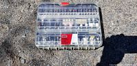 Full top-down view of rotary tool accessory kit in transparent plastic storage case showing all included accessories and packaging sticker.
