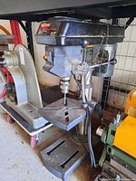 Front angle view of Craftsman 10 inch drill press showing work table, handle and drill chuck.