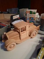 Front side view of the handmade wooden vintage truck model showing detailed craftsmanship and natural wood finish.