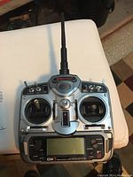 Front view of the Spectrum DX7 remote controller showing joystick, display, switches and antenna.