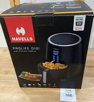 Front of box showing brand, model, wattage, and image of air fryer with fries.