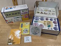 Two Traditional Chinese Medicine cupping kits: one sealed and unused, one used with cups and pump arranged in box