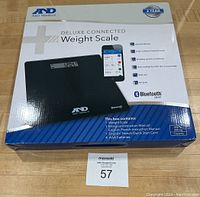 Front view of the boxed weight scale showing brand, model, and included contents, confirming new unopened condition.