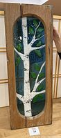 Front view of the stained glass panel showing a white birch tree with green leaves in a rustic wooden frame.