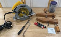 Photo showing DeWalt circular saw, wooden woodworking vice, Klein flexible placement tool, and markers on wooden surface.