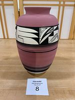 Front view of Ute Mountain Pottery vase showing dusty rose finish with cream and black geometric band around middle. Signed Wing.