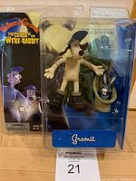 Front view of the McFarlane Toys Wallace & Gromit Gromit figure with Rabbit in Sack in original packaging showing colorful branding and artwork.