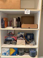 Shelf with assorted computer software boxes, cables and blank media