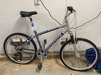 Full side view of bike leaning against wall