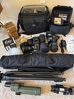 Overview of all items including camera bags, lenses, tripods, diffuser, flash, charger, scope, manuals